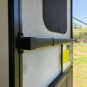 Horizontal grab bar handle installed on a caravan screen door beside the entry lockscrews