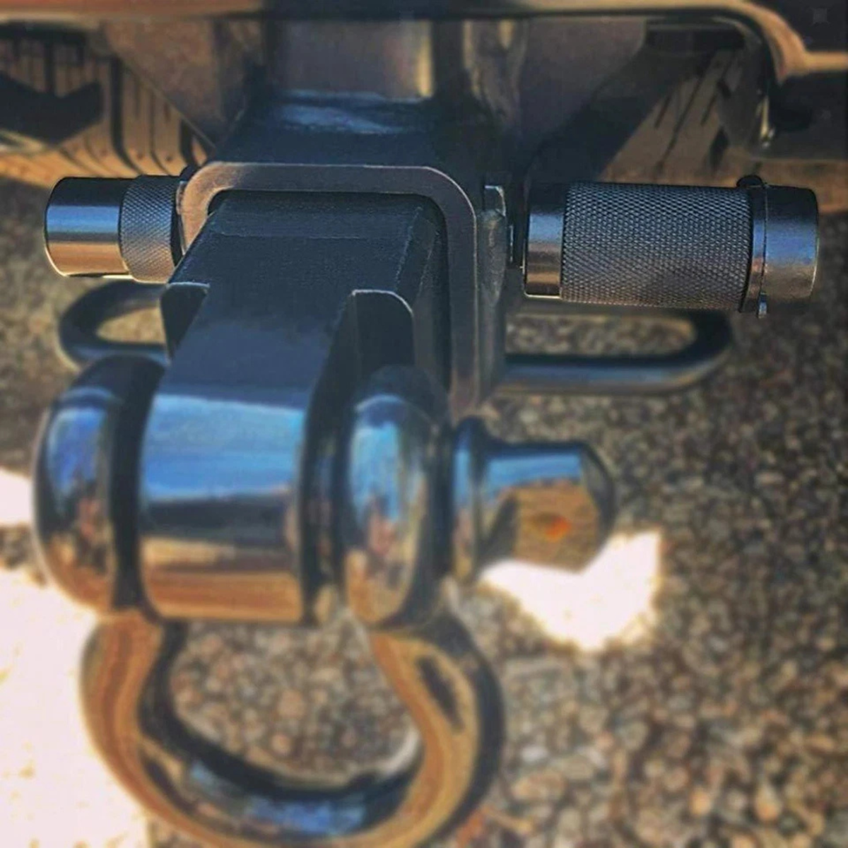 Locking hitch pin fitted through a tow bar receiver